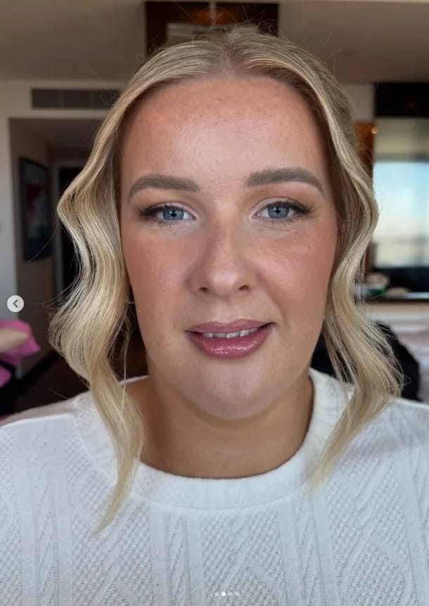 Bride with face-framing waves, dewy skin and a glossy mauve lip in a white knit sweater