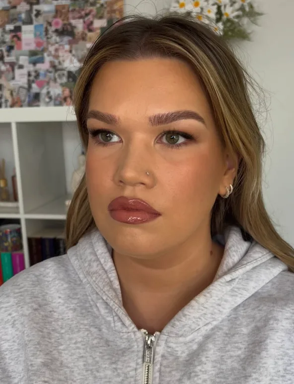 Soft glam with feathered brows, glossy mauve lips and a natural flush